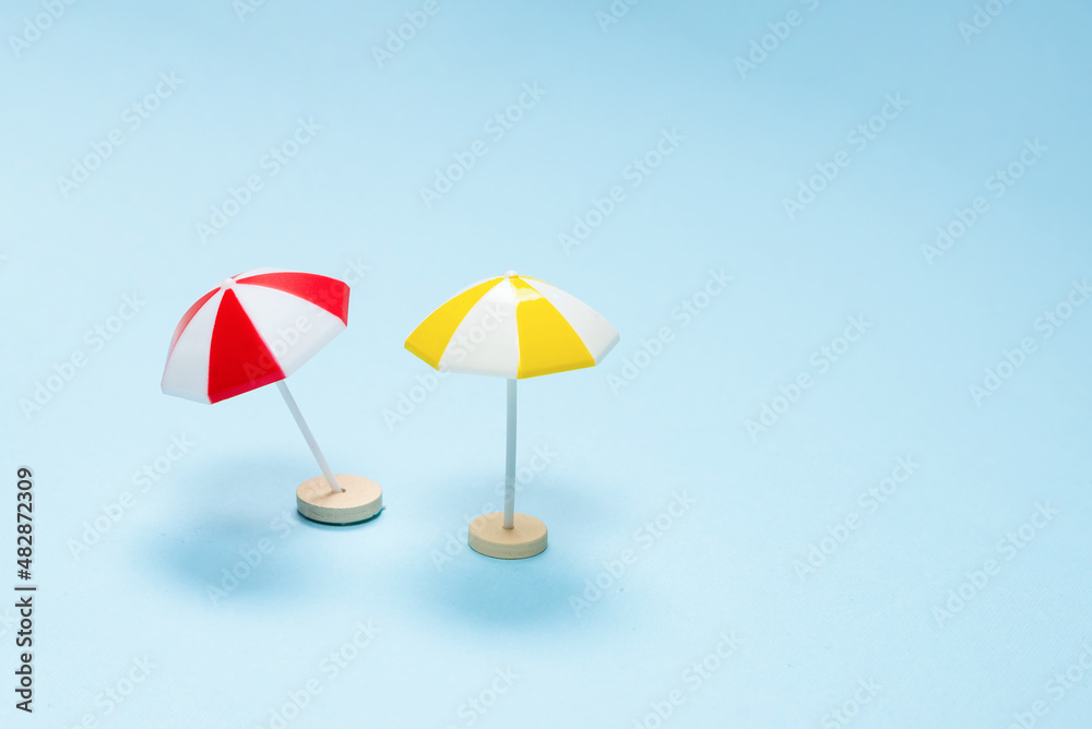 Yellow and red umbrella on a blue background.
