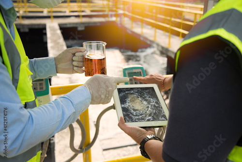 Wastewater treatment concept. Service engineer on  waste water Treatment plant and checking oxygen in water with tablet.