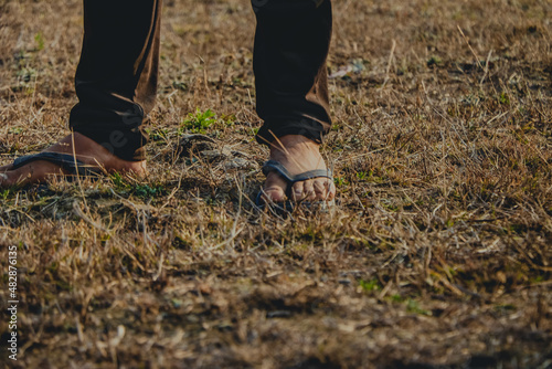 walking on the grass, wearing slippers © Dev
