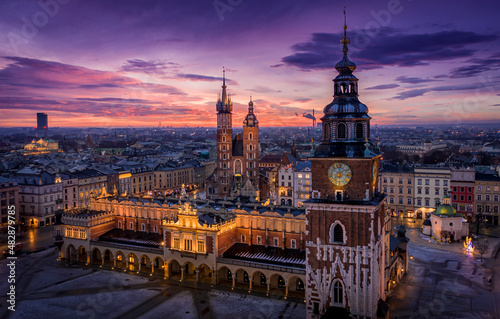 Panorama of Main Square (Saint Mary's Basilica, Sukiennice - Town Hall, Town Hall Tower) in Krakow during magic dawn in winter, Poland