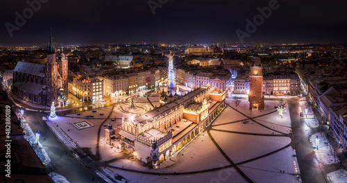 Panorama of Main Square (Saint Mary's Basilica, Sukiennice - Town Hall, Town Hall Tower) in Krakow at night in winter, Poland photo