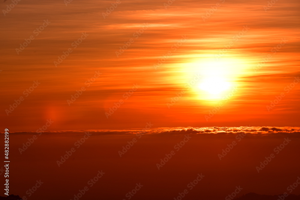 The sun set behind thick forests followed by mountains. The sun set behind thick forests followed by mountains.