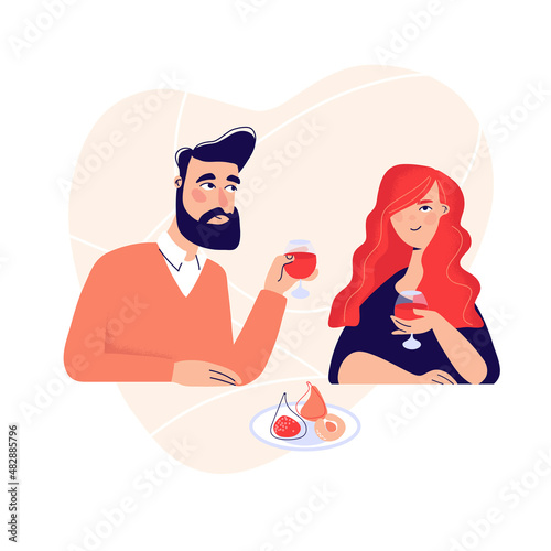 Dating. Valentines day celebration. Sweet happy young couple having romantic dinner with glasses of red wine on date.Drink wine.Pair couple together at the dinner table.