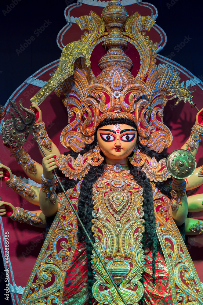 Goddess Durga idol , Durga Puja festival at night. Shot under colored light at Howrah, West Bengal, India.