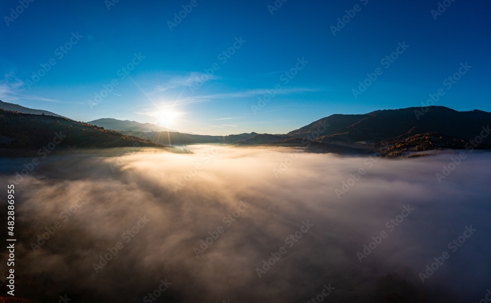 Highland covered with evergreen forest and fog in canyon