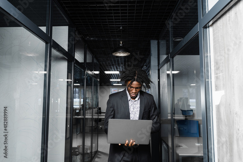 Wallpaper Mural Focused young black businessman working online on laptop in office. Remote work. Torontodigital.ca