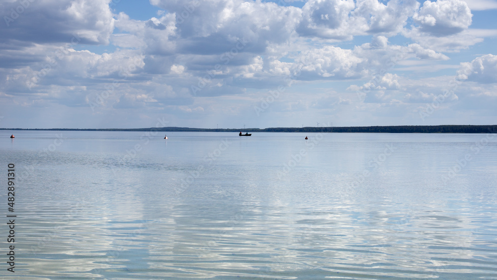 Reflection of white clouds in the mirror of clear water