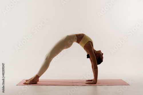 young woman doing yoga poses on white background