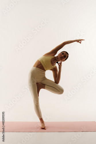 young woman doing yoga poses on white background