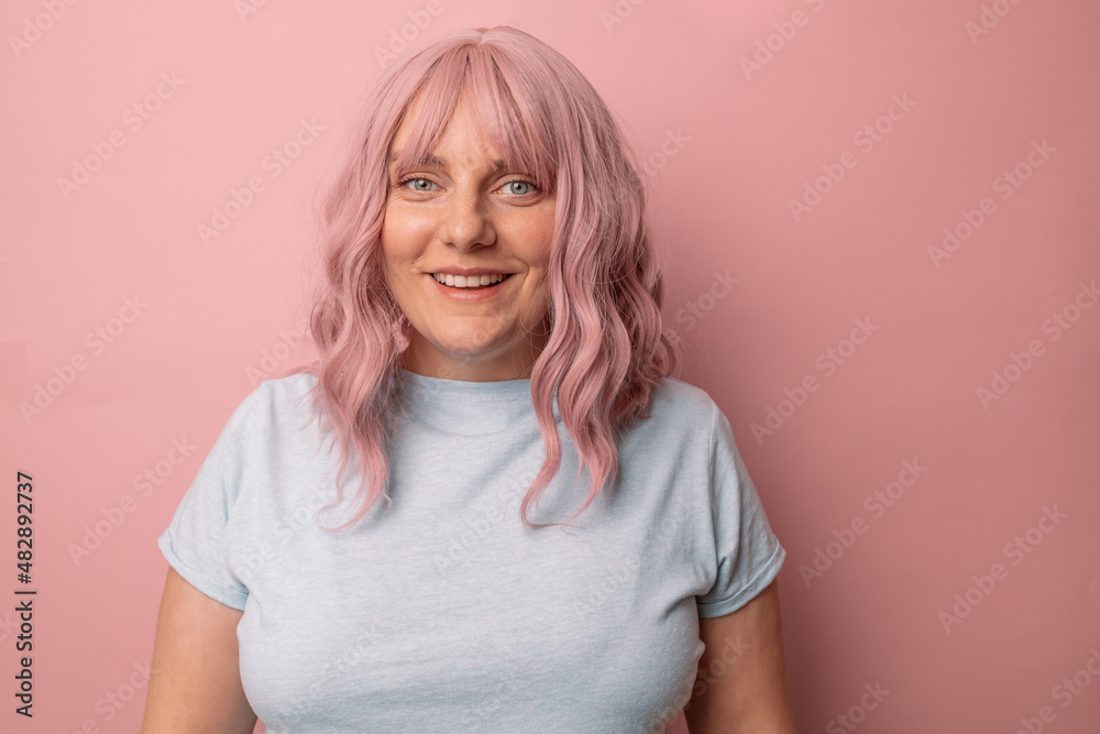 Portrait of smiling woman in good mood posing against pink background. people concept Portrait of smiling woman in good mood posing against pink background. people concept