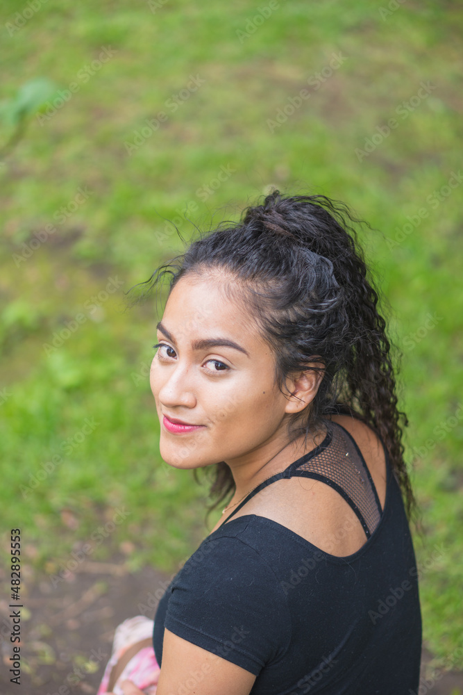 Young woman posing for a photograph. Young woman posing for a photograph.