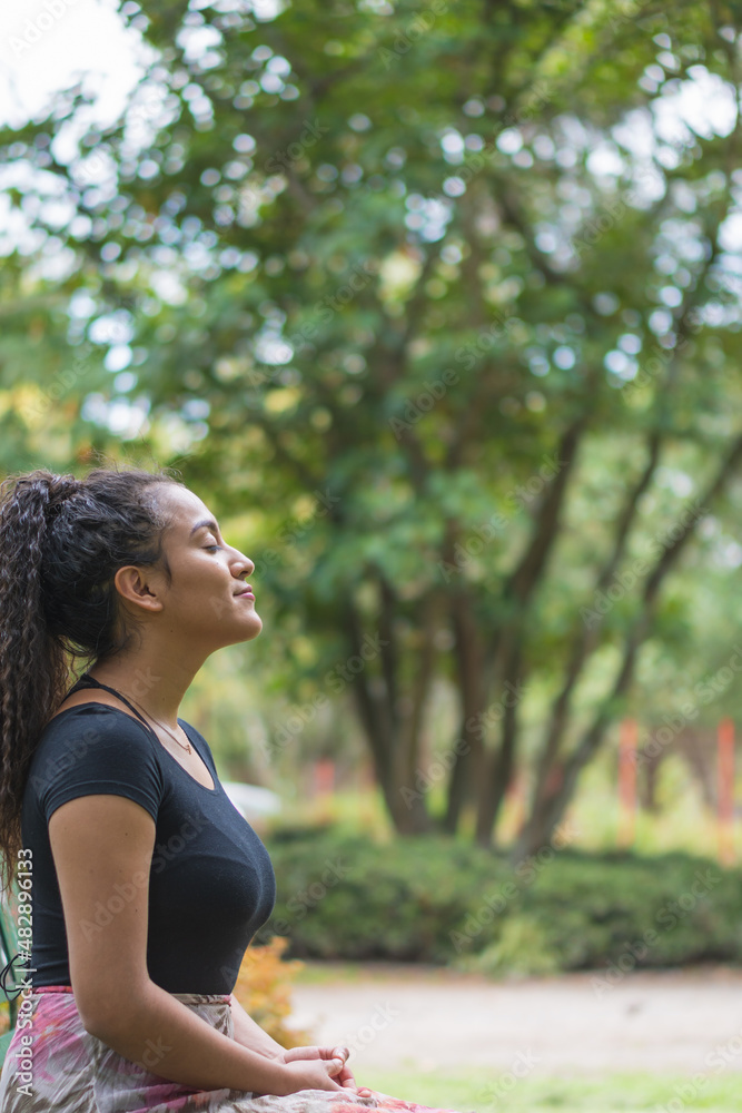 Young woman enjoying the outdoors in the park.