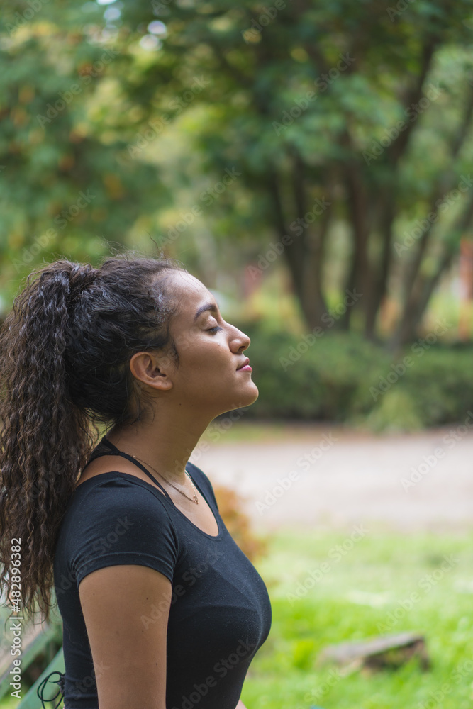 Young woman enjoying the outdoors in the park. Young woman enjoying the outdoors in the park.