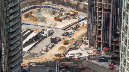 Photography Cranes and bulldozers working at construction site of new skyscraper aerial timelapse