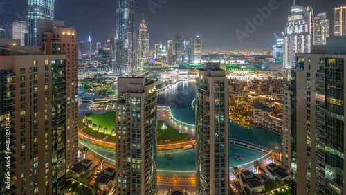 Dubai Downtown cityscape with tallest skyscrapers around aerial all night timelapse.