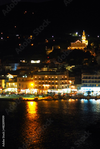 night view of the port of Tinos, a magnificent island of the Cyclades in the heart of the Aegean Sea, dominated by the church of Panaghia Evangelistria