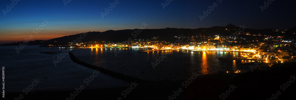 Superb panoramic night view of the port of Tinos, a magnificent island of the Cyclades in the heart of the Aegean Sea, dominated by the church of Panaghia Evangelistria