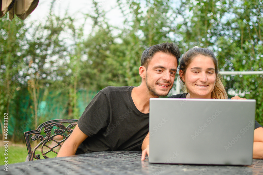 Emotion. young caucasian couple having a video call and smiling to their laptop. Emotion. young caucasian couple having a video call and smiling to their laptop.