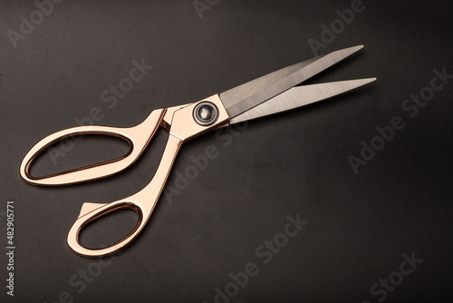 large sewing metal scissors on a black background