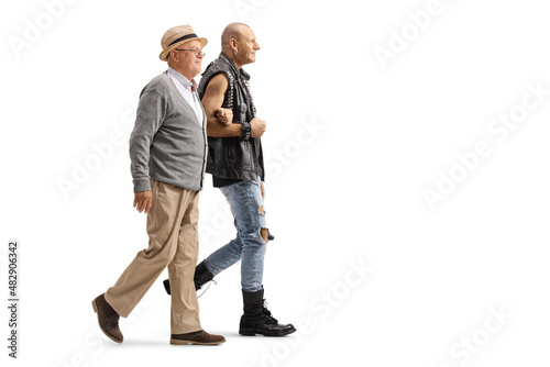 Full length profile shot of a punk holding an elderly man under arm and walking