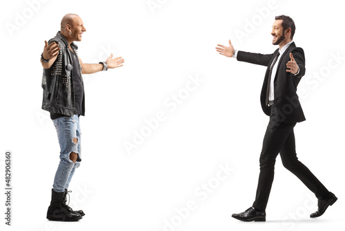 Full length profile shot of a businessman and a punk meeting with arms wide open