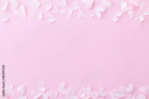 Happy Valentine's Day! Stylish valentine hearts flat lay on pink background. Valentines day card template. Cute little white cutouts hearts frame on pink paper. Love concept © sonyachny