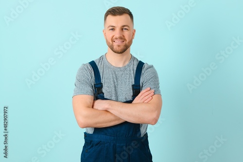 Close-up portrait of his he nice attractive cheerful cheery content guy repairer craftsman isolated over blue color background. photo