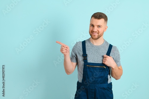 Close-up portrait of his he nice attractive cheerful cheery content guy repairer craftsman isolated over blue color background. photo