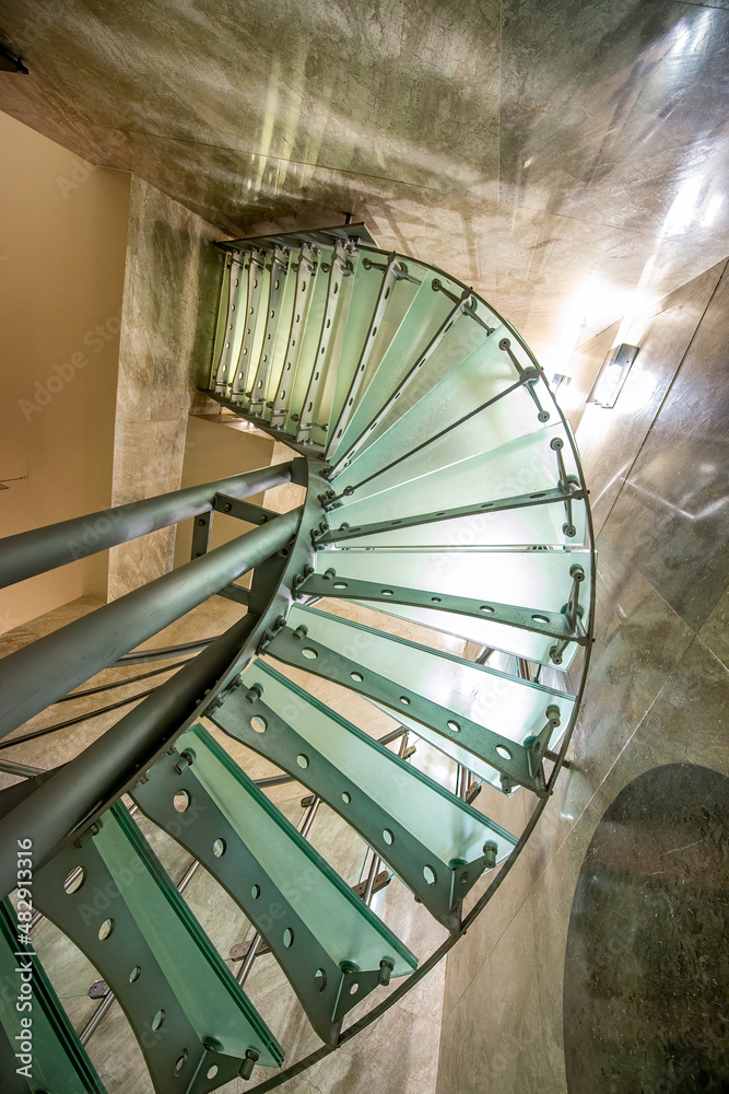 Fototapeta premium Geometric view of modern staircase by looking upwards.