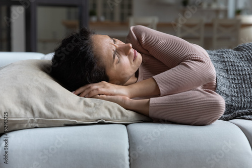 Принти на полотні Woman suffer from restless sleep, having insomnia or nightmares, frowning lying on sofa with closed eyes cant fall asleep