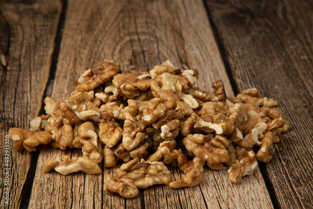 Walnuts on a wooden background.A natural protein product. Walnuts on a wooden background.A natural protein product.