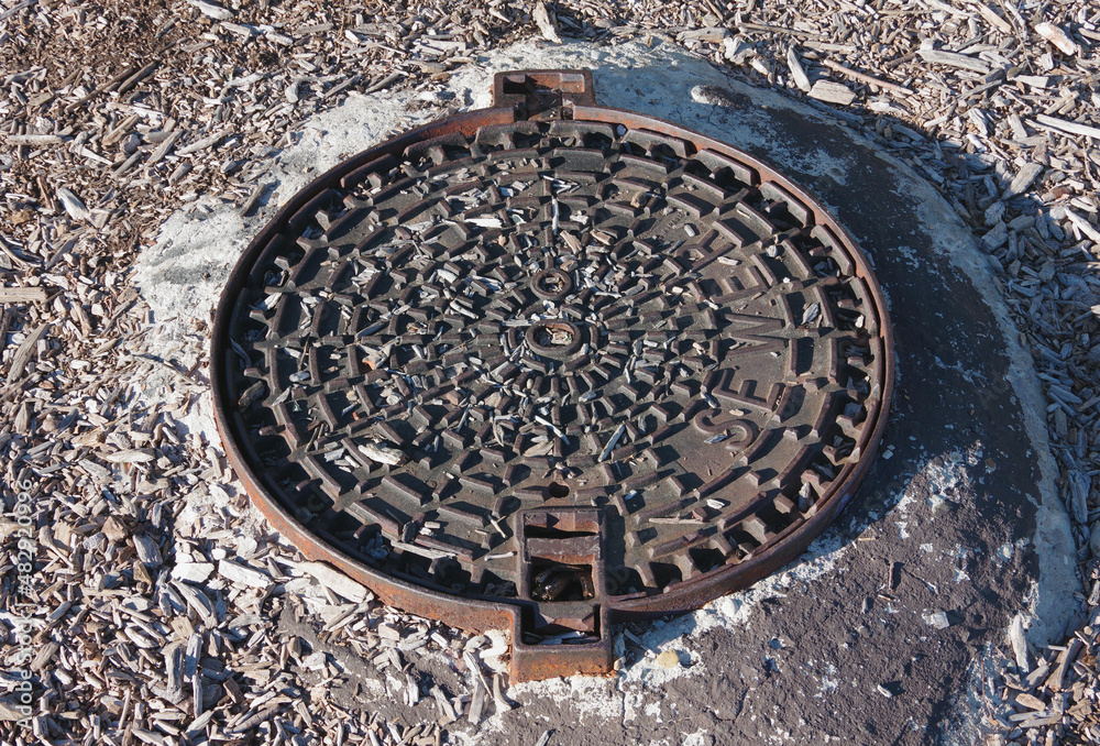 Heavy sever manhole iron cover plate in parkland grounds