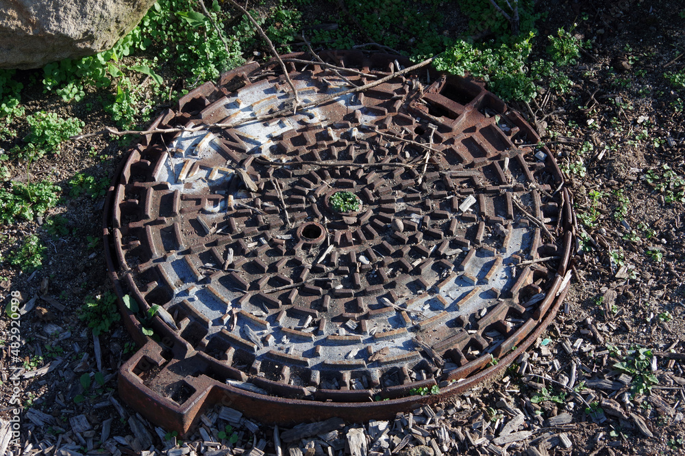 Heavy sever manhole iron cover plate in parkland grounds