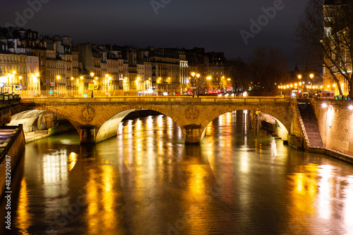 Night Paris, Pont au Change, reflection of lights in the river Seine, cityscape