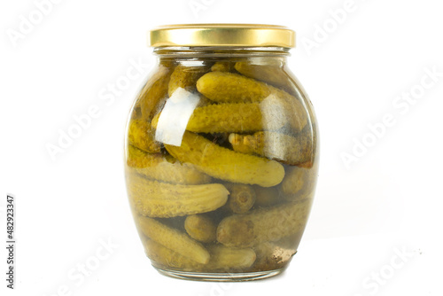 canned cucumbers on a white background in a glass jar