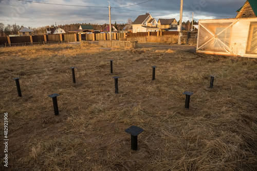 Pile foundation for the construction of a private house. Metal screw piles. The foundation of the house.
