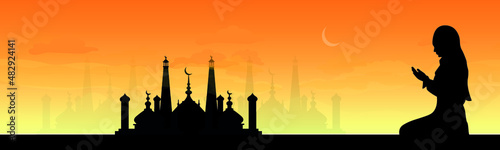 Panorama of Ramadan Kareem. Ramadan Mubarak. The woman is praying. Arabian night with crescent moon
