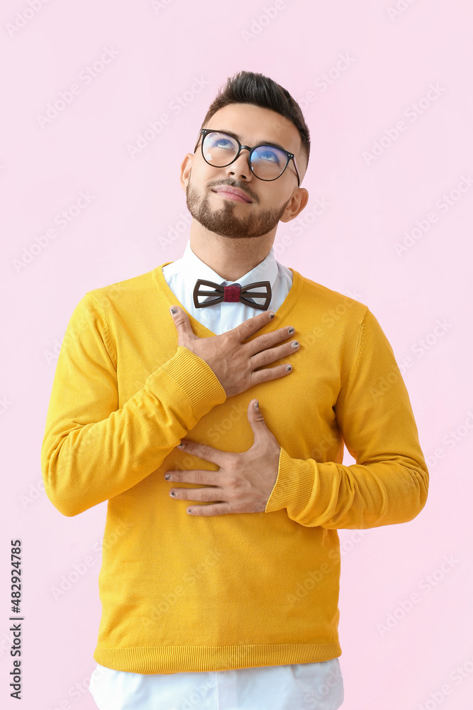 Dreamy man with stylish manicure on color background