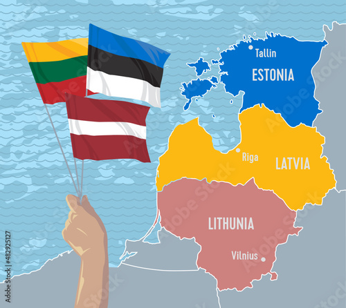 Hand holds the flags of Latvia, Lithuania and Estonia, which symbolizes unity for independence against the background of the map of the Baltic States.