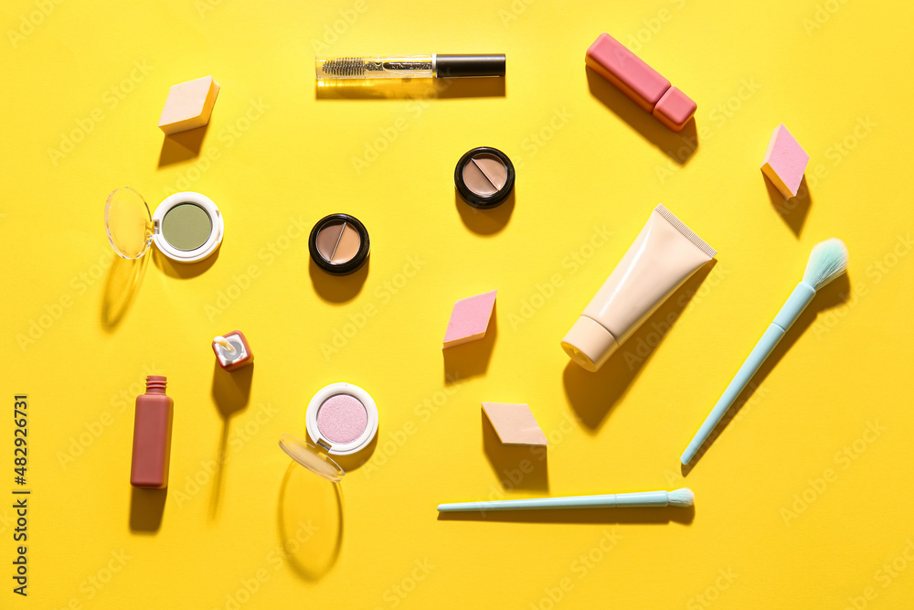 Decorative cosmetics on yellow background Decorative cosmetics on yellow background
