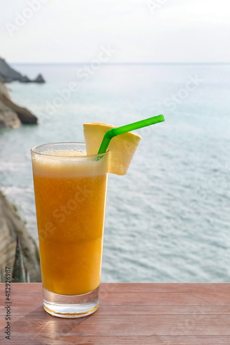 Glass of fresh cocktail on table at sea resort