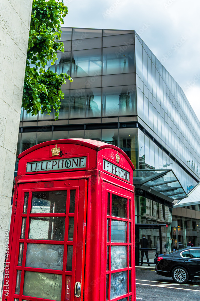 Red Telephone booth in London with reflection of St Paul's Cathedral in the backround Red Telephone booth in London with reflection of St Paul's Cathedral in the backround