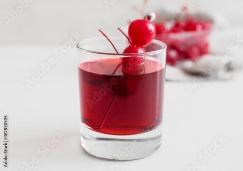 Wallpaper Mural Glass of tasty Manhattan cocktail with cherries on light background, closeup Torontodigital.ca