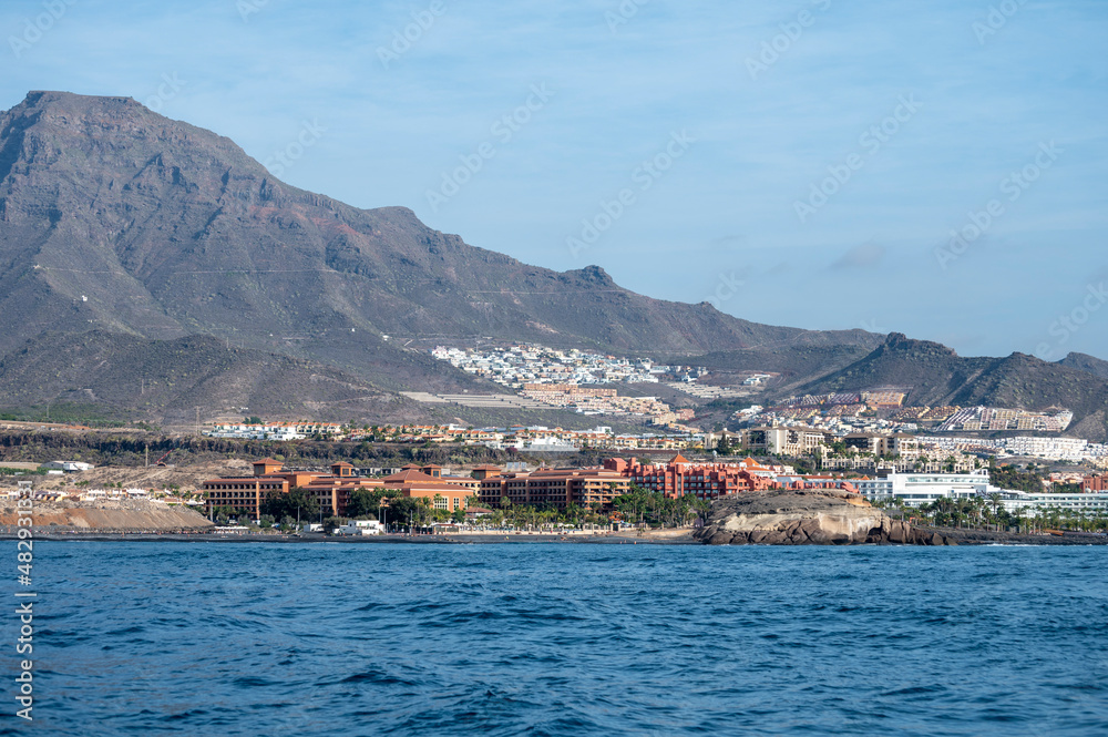 Fototapeta premium View on resorts and beaches of South coast of Tenerife island during sail boat trip along coastline, Canary islands, Spain