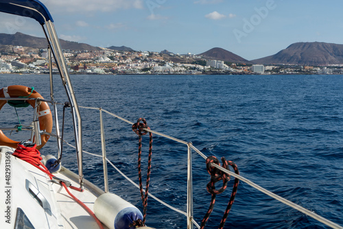 View on resorts and beaches of South coast of Tenerife island during sail boat trip along coastline, Canary islands, Spain © barmalini