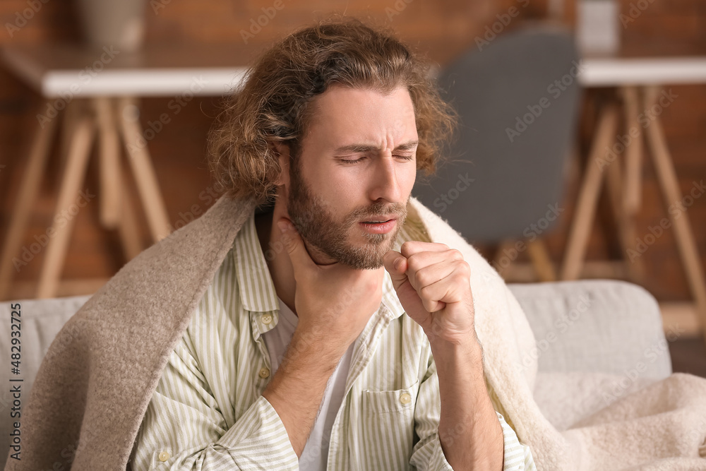 Ill man with sore throat at home Ill man with sore throat at home