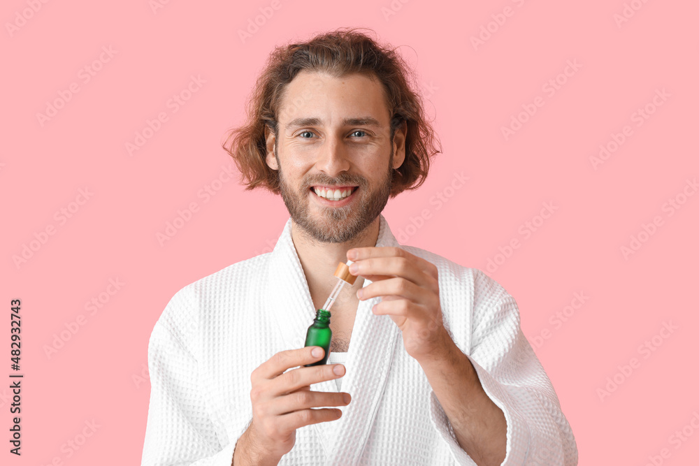 Young man with cosmetic serum on color background Young man with cosmetic serum on color background