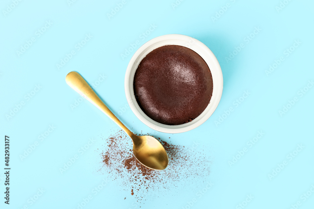 Ramekin with tasty lava cake fondant on blue background Stock Photo