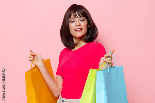 portrait woman with colorful shopping bags isolated background