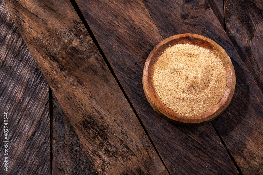 Lepidium meyenii - Maca powder in the wooden bowl Lepidium meyenii - Maca powder in the wooden bowl